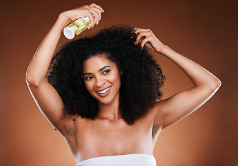 Image showing Hair care, afro and spray with wellness, cosmetic and happy smile against a brown studio background with mockup. Happiness, health and care for curls with beauty, natural or luxury cosmetics product