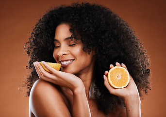 Image showing Lemon, natural beauty and black woman in studio for skincare, hair care and vitamin c cosmetics promotion, marketing or advertising. Happy model smell lime fruits for detox or skin care benefits