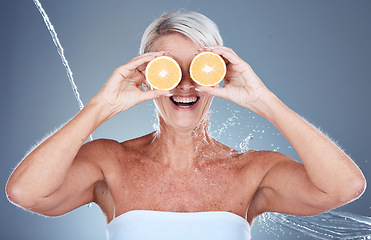 Image showing Woman, water splash and lemon fruit skincare grooming for vitamin c treatment, facial blemish or dermatology cosmetology. Smile, happy or mature beauty model with citrus food or product covering eyes