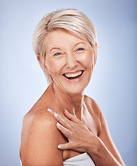 Image showing Face portrait, skincare and senior woman in studio isolated on blue background. Makeup, beauty and mature female model from Canada with glowing, healthy and flawless skin after cosmetic spa treatment