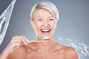 Image showing Senior woman, brushing teeth and water splash on bamboo toothbrush for clean dental hygiene, wood healthcare product and mouth wellness. Happy smile, eco friendly toothpaste and tooth cleaning mockup