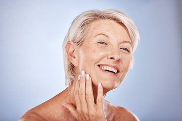 Image showing Face, beauty and antiaging with a senior woman touching her skin in studio on a gray background for wellness. Portrait, cosmetics and treatment with a mature female posing to promote natural care