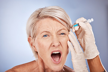 Image showing Syringe, face surgery or senior woman in pain getting plastic injection, medical skincare or healthcare facial product. Medicine, aesthetic or skin dermatology beauty spa, wellness model or prp.