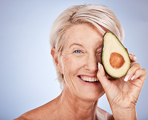 Image showing Face, skincare and avocado with a senior woman in studio on a gray background to promote antiaging antioxidants. Portrait, cosmetics and natural treatment with a mature female posing for wellness