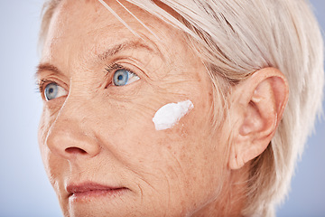 Image showing Skincare, beauty and old woman with facial cream in studio posing for face and body care. Wellness, healthcare and senior female with sunscreen, lotion and antiaging skincare products for dermatology