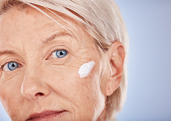 Image showing Cream, senior woman and skincare facial lotion, sunscreen and makeup product, beauty wellness or anti aging cosmetics on studio background. Portrait of mature lady, face cream and aesthetic body care