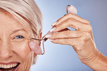 Image showing Skincare, face roller and senior woman facial massage in studio portrait zoom for healthy skin, cosmetics product and wellness promotion. Beauty old woman model with stone rose quartz for dermatology