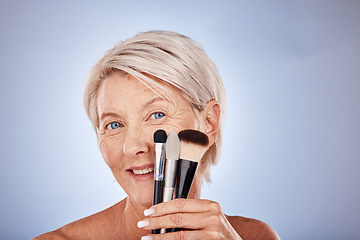 Image showing Makeup, brush and portrait of senior woman with product for foundation application, studio cosmetics or anti aging skincare. Beauty, healthcare and aesthetic face of elderly model with facial routine