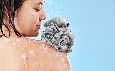 Image showing Shower, sponge and woman cleaning body with water, soap foam and skincare for wellness, personal hygiene and cosmetics on mockup studio blue background. Asian girl model, beauty and bath with loofah