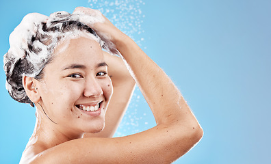 Image showing Water, shampoo and woman in shower on blue background, haircare and hygiene routine in the morning. Model in shower cleaning hair, soap and foam with running water for clean fresh beauty with mockup