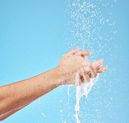 Image showing Cleaning hands, water splash and wash for hygiene, healthcare and wellness mockup on a blue studio background. Skin hydration, moisturizing skincare skin and protect from bacteria, germs and disease