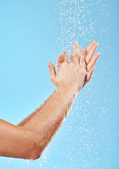 Image showing Woman, water splash and washing hands on blue background in studio for bacteria safety, hygiene maintenance or morning grooming. Zoom, model or skincare shower cleaning in wet healthcare or wellness