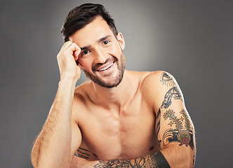 Image showing Man, beauty and sexy with body, tattoo and happy portrait against grey studio background with mockup space. Male model, sexy and smile for self care, skincare and cosmetic wellness with clean face