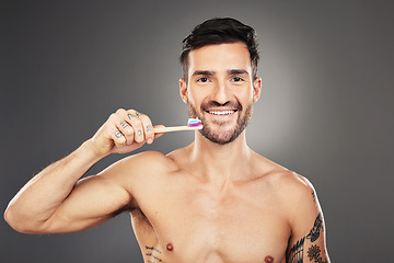 Image showing Dental hygiene, man and brushing teeth for health, wellness and body care against grey background. Portrait, oral health and male with toothbrush, fresh breath and healthy with smile and toothpaste.