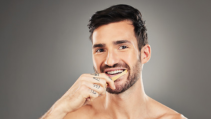 Image showing Man, brushing teeth and dental healthcare for beauty smile or grooming morning routine with toothbrush in studio. Face, smile and hygiene health with model cleaning teeth portrait in grey background