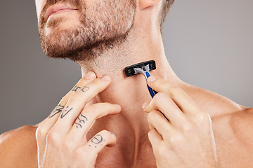 Image showing Grooming, beard and man shaving hair for skincare, wellness and health against a grey studio background. Dermatology, hygiene and hands of a model with a razor to shave neck for a fresh treatment