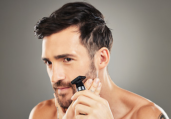 Image showing Thinking, shaving and man with a razor for his face, skincare and beauty against a grey studio background. Cosmetic, clean and man with an idea for healthy beard, facial hair and health of skin