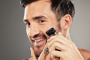 Image showing Face, skincare and man shaving with razor in studio isolated on gray background mockup. Smile, wellness and happy male model from Australia shave beard or facial hair for grooming, beauty or hygiene