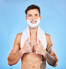 Image showing Shave, grooming and hygiene with a man model in studio on a blue background for body or skincare. Portrait, hair removal and beauty with a handsome young male posing to promote hygienic shaving