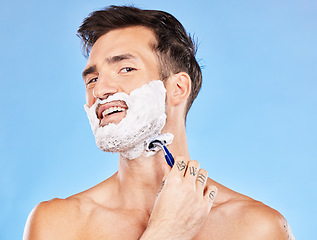 Image showing Skincare, shaving and face foam man with facial razor for hair removal, beauty and grooming marketing. Wellness, self care and beard cosmetic model with blue studio advertising mock up.