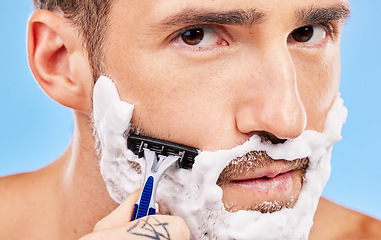 Image showing Shaving face, hair removal and man with razor in grooming and hygiene portrait, cream on beard to clean and beauty with studio background. Foam, moisturizer and cleaning with skincare and wellness.