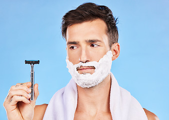 Image showing Man doubt, shave and face in studio with razor, thinking or cosmetics for self care, beauty and foam. Grooming, facial health and skincare with shaving cream, beard and contemplating in bathroom