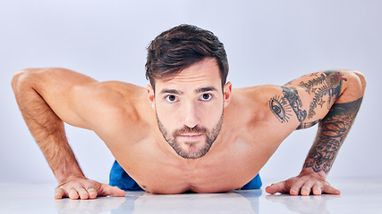 Image showing Portrait, man and push up on studio floor for fitness, cardio workout or strong muscle development. Young bodybuilder, training and exercise for motivation wellness health or natural happy lifestyle