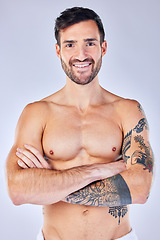 Image showing Portrait, body and hygiene with a man model standing arms crossed in studio on a gray background. Health, wellness and skincare with a handsome young male posing arms folded for wellness or luxury