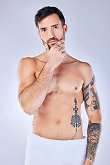 Image showing Man, thinking and tattoo with a towel, shower and sexy against grey studio background with mockup space. Portrait, idea and male model with creative body ink, art and after a bath, clean or beauty