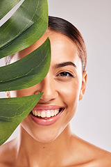 Image showing Leaf, woman and beauty, natural skincare and clean cosmetics for wellness, glow and sustainability on studio background. Portrait of happy model face, green monstera leaves and eco plants dermatology