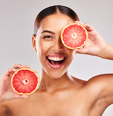 Image showing Grapefruit, woman skincare and beauty, vitamin c and wellness, healthy facial aesthetics and natural cosmetics of dermatology on studio background. Portrait happy model, body nutrition and detox diet