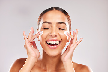 Image showing Skincare, beauty and woman with face cream in a studio doing a natural face and skin routine. Cosmetic, wellness and happy girl model with facial lotion, spf or sunscreen isolated by gray background.