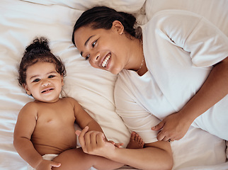 Image showing Top view, mama and baby with smile, on bed and happy together for bonding, childhood and loving in home. Love, mom or toddler in bedroom, happiness or positive for wellness, tenderness and motherhood