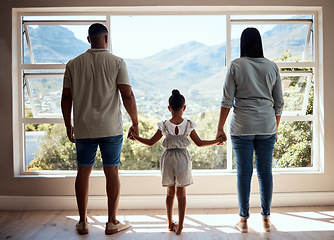 Image showing Family, child or girl by window in new house, home or apartment with mortgage loan, finance security or future investment property. Mother, father and kid as real estate homeowner with mountains view