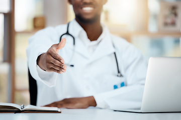 Image showing Doctor, laptop and greeting, welcome or handshake in hospital, office or clinic. Shaking hands, helping hand and black medical physician offering help, assistance or onboarding, deal and thank you.