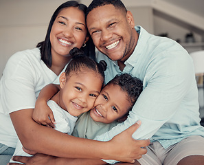 Image showing Happy, smile and portrait of family hugging, bonding and relaxing together in their home. Loving, father and mother holding their children with love, care and happiness in the living room in a house.