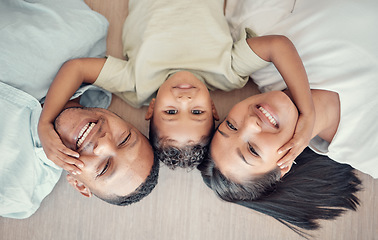 Image showing Top view, family and boy bonding on floor in house living room or home bedroom for mothers day, fathers day or love. Portrait, smile and happy man, woman and child in trust, security and love support