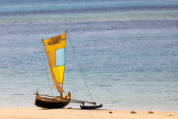 Image showing Tranquil scene of a wooden fishing boat resting on the golden sands of Nosy Ve, Madagascar