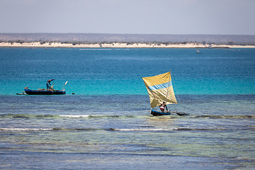 Image showing Beautiful scenery of a colorful fishing boat and fisherman sailing on a calm sea under the warm sun of Madagascar