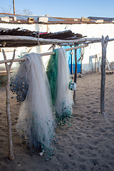 Image showing Traditional fisherman's net hangs in the warm sunshine on the beach of Anakao village in Madagascar