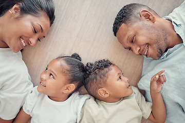 Image showing Top view, family and children with smile, on floor and happy together being loving, bonding and childhood in home. Love, parents or toddler twins with happiness, positive and wellness with tenderness