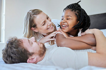 Image showing Relax, adoption and diversity with family in bedroom for happy, support and bonding in the morning. Wake up, smile and playing with foster care child and parents at home for affection, trust or funny