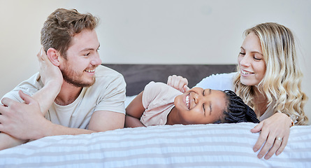 Image showing Family, adoption and love with happy, smile and care together on bed, relax and fun on weekend in home. Diversity, bedroom and happiness with bonding, support and relaxing with moth, father and girl