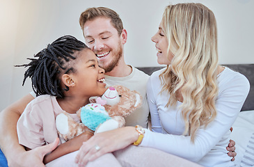 Image showing Happy family, parents and adoption kid in bedroom, family home and house for fun, bonding and quality time with love, care and happiness together. Black kid relax with foster mom, dad and diversity