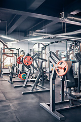 Image showing Gym, equipment and weights of fitness background for exercise, training or heavy workout for strength building and wellness. Empty health club of interior space and machines or tools for exercising