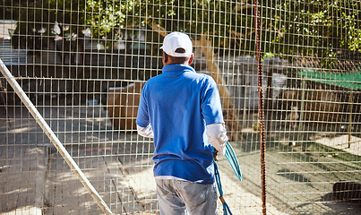 Image showing Volunteer, charity and animal shelter with a black man working at a rescue center for the adoption of foster pets. Worker, community and care with a male employee at work alone with rescue animals