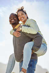 Image showing Happy, couple and piggy back enjoy fresh air on vacation outdoor with blue sky background. Smile, black man and happiness woman being playful and having fun together on a romantic date in nature park