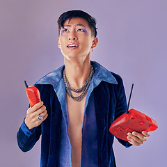 Image showing Fashion, telephone and confused man in studio isolated on a purple background. Gen z punk, phone call decline and gay model from Japan in makeup with retro, vintage phone and outdated technology.