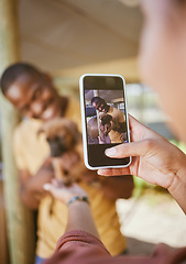 Image showing Phone picture, dog and woman hand showing man and new pet outdoor with happiness. Black man, puppy and black woman together with couple bonding hug using mobile technology and camera with a smile