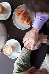 Image showing Couple, hands and food at restuarant for quality time or relationship bonding together. Love, relax and support holding hands or talking at cafe dinning table for lunch, dinner or trust conversation